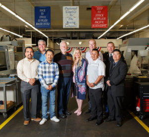 Robin and group standing at business